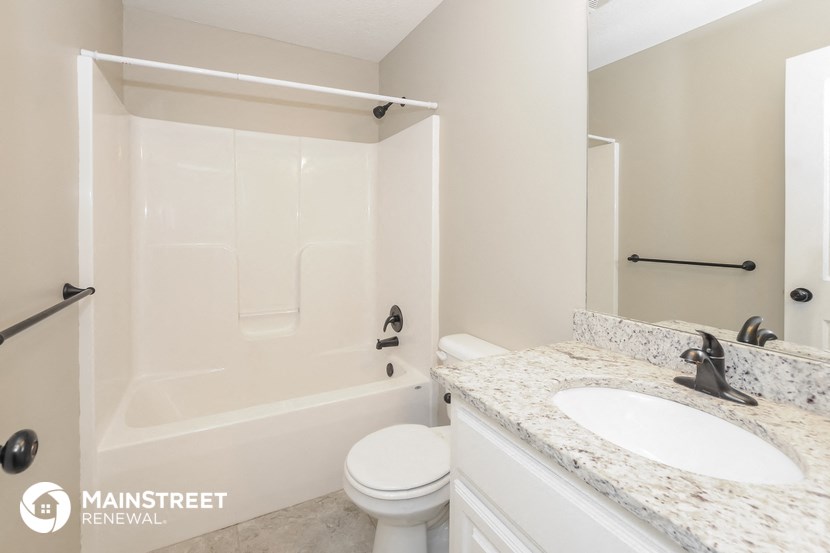 a bathroom with a sink and a toilet and a shower