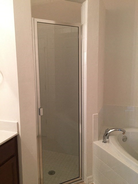 a small bathroom with a shower and a sink