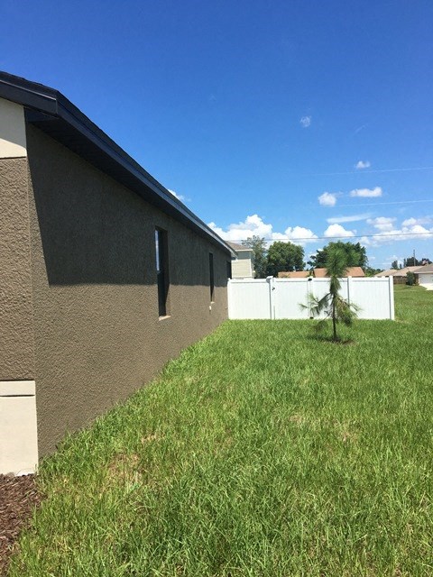 a view of the side of a house with a grassy yard