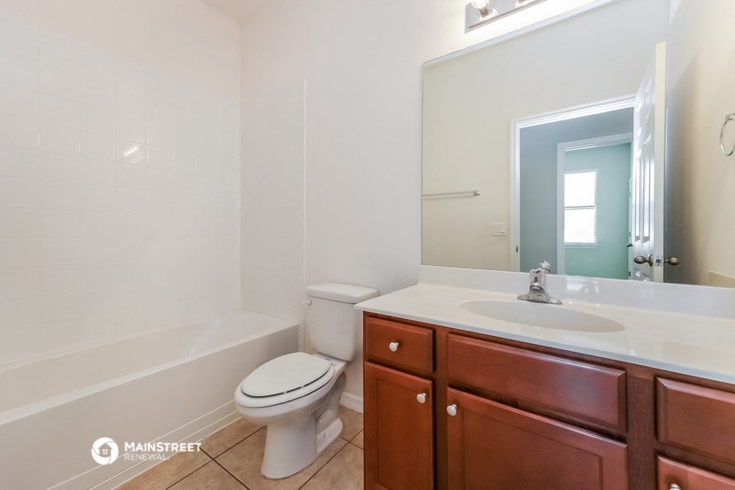 a bathroom with a sink toilet and a mirror