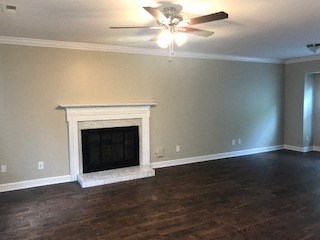 a living room with a fireplace and a ceiling fan