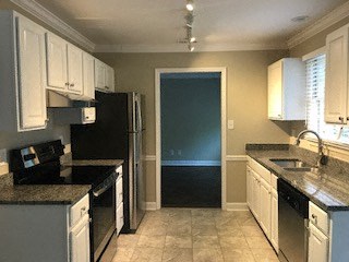 a kitchen with a sink and a refrigerator