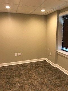 a empty room with a window and a carpeted floor