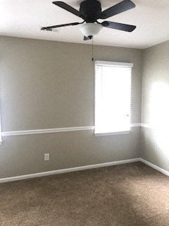 an empty room with a ceiling fan and a window