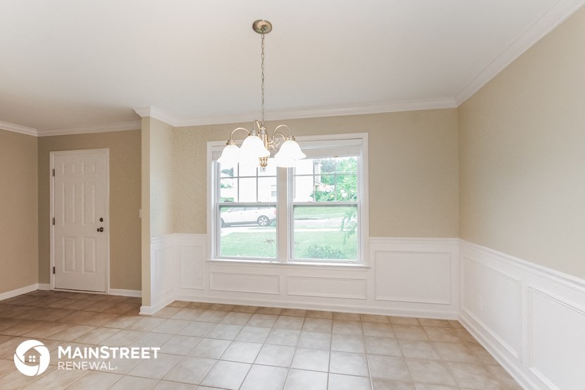 an empty dining room with a large window