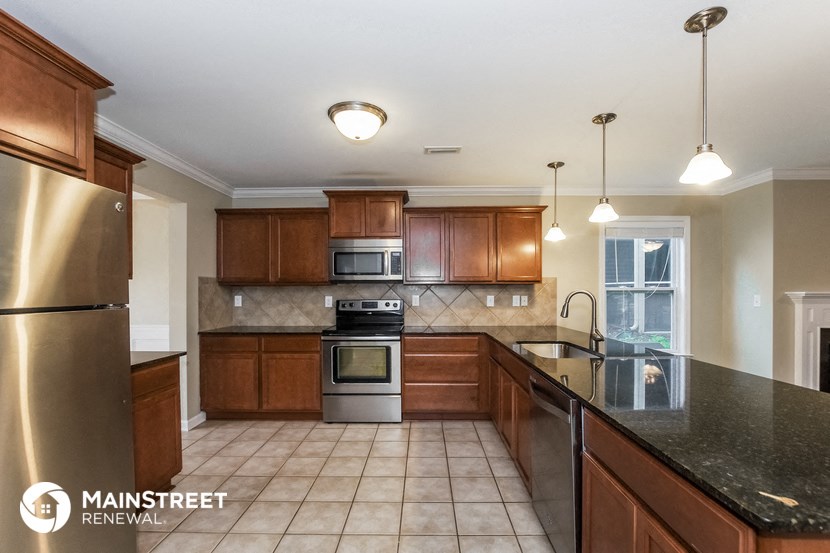 a kitchen with wooden cabinets and stainless steel appliances
