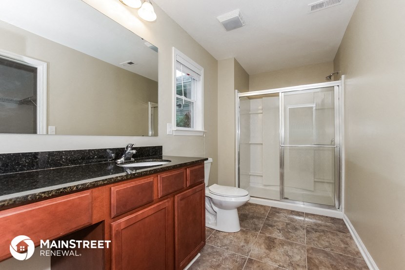 a bathroom with a sink and a toilet and a shower
