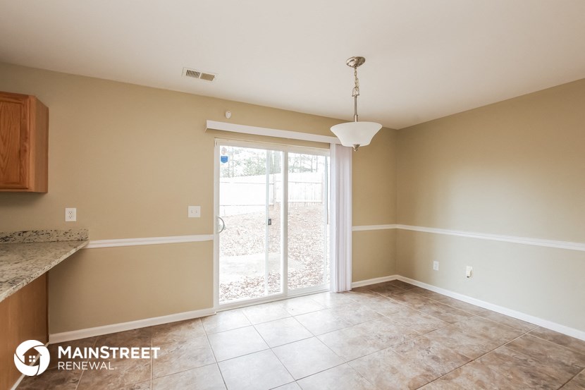 an empty living room with a sliding glass door