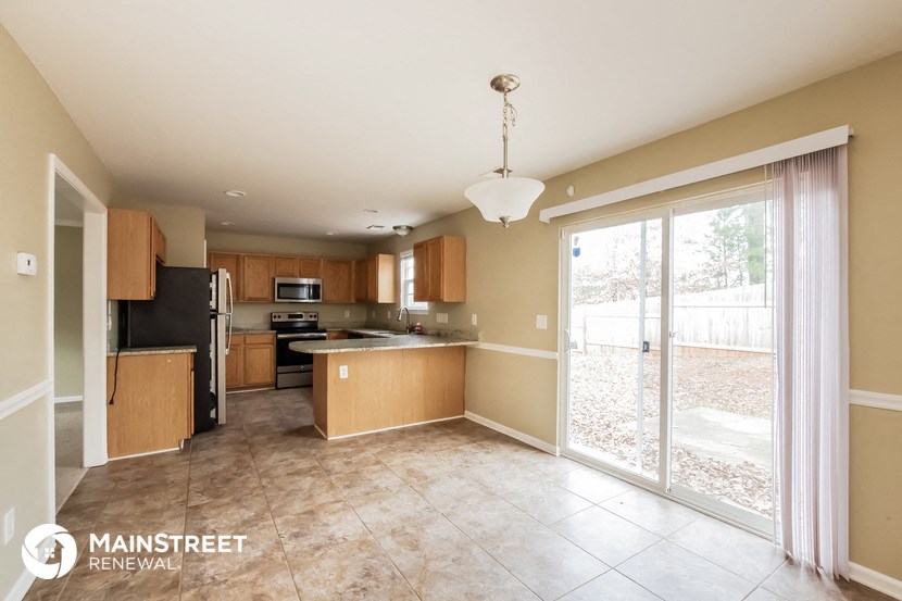 a large kitchen with a sliding glass door to the patio