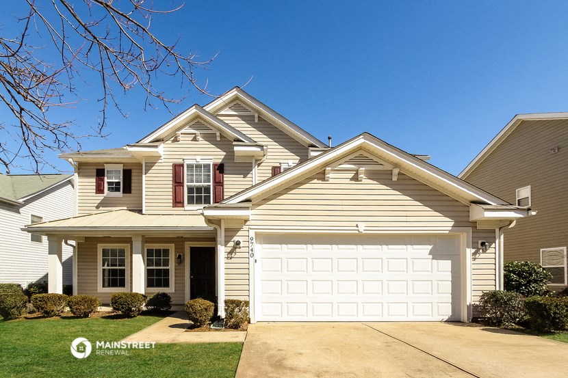 a tan house with a white garage door