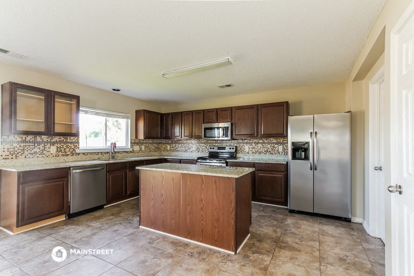 a kitchen with stainless steel appliances and wooden cabinets