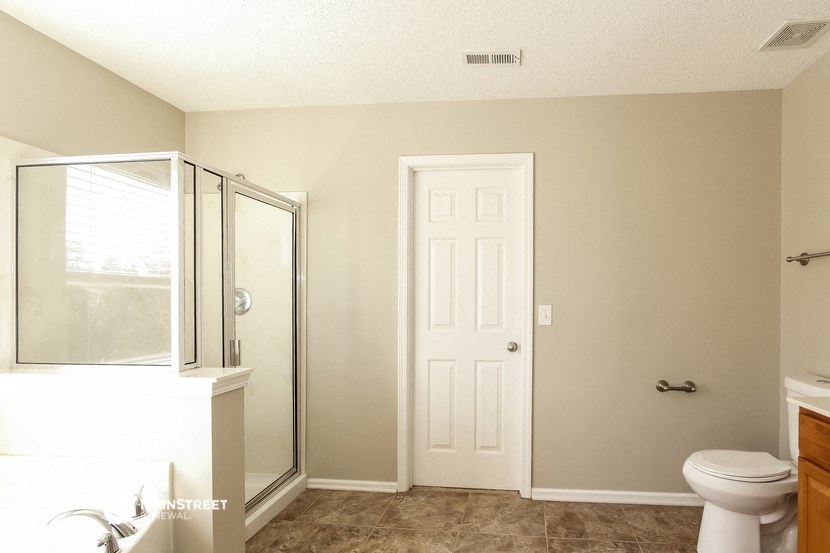 a small bathroom with a shower and a toilet