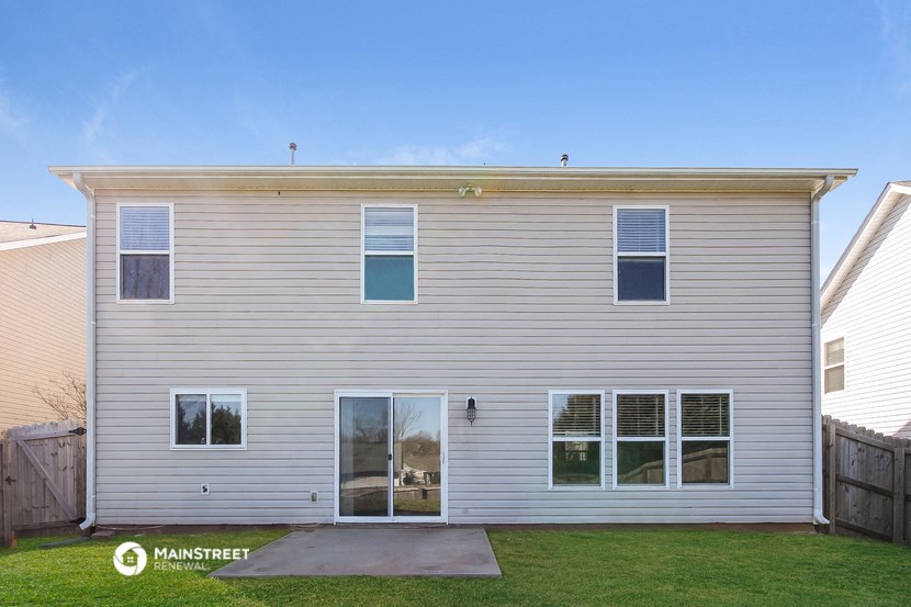 a white house with white siding and a yard