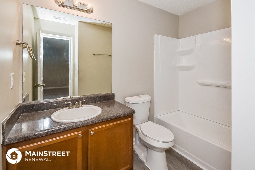 a bathroom with a sink toilet and a shower