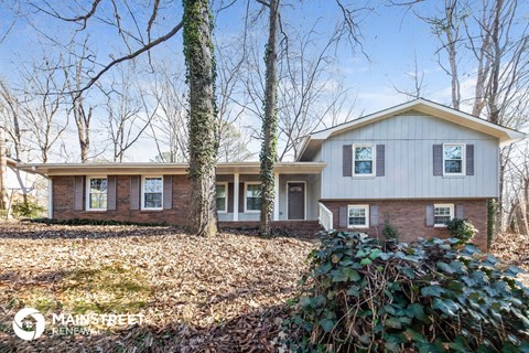 front view of a white house in the woods