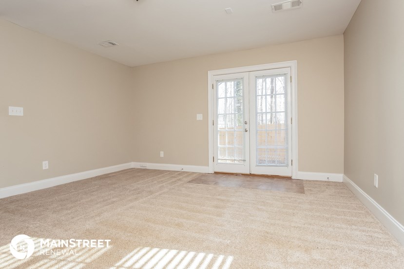 the spacious living room doors to the patio