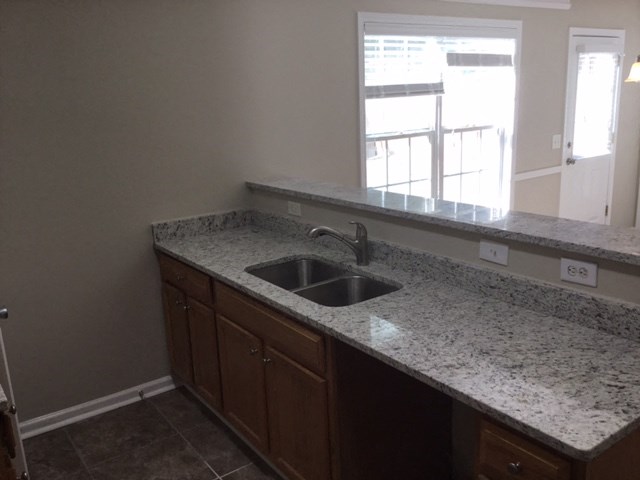 a kitchen with granite counter tops and a sink