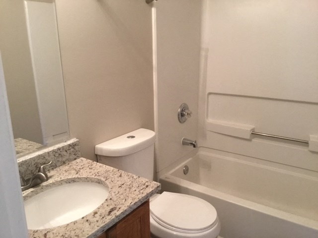 a bathroom with a sink toilet and a bath tub