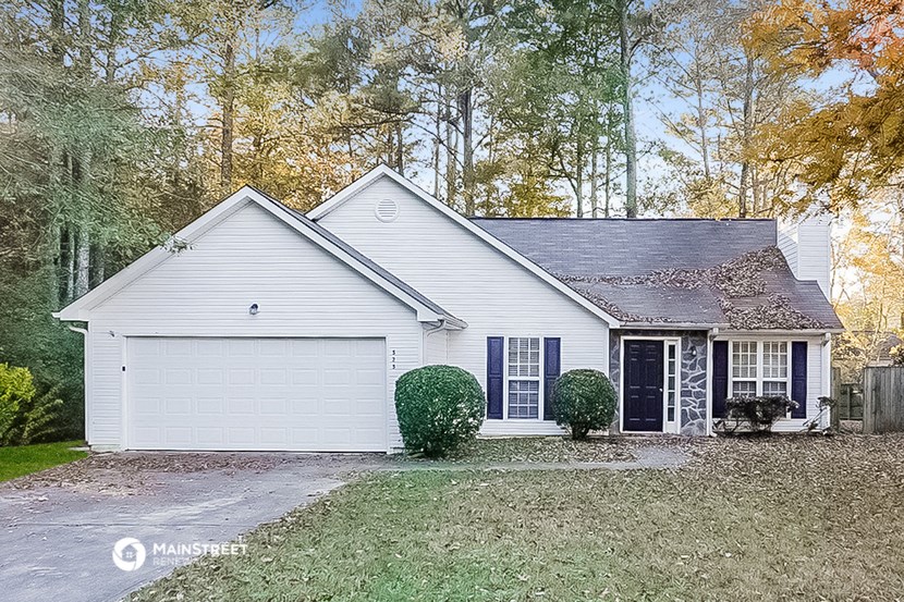 a white house with blue shutters and a yard