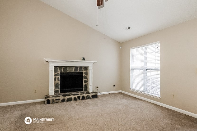 a living room with a fireplace and a window