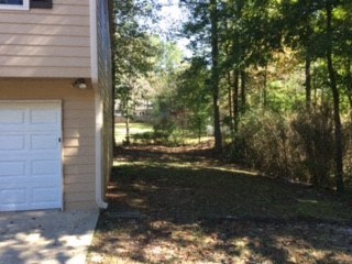 a garage with a white door on the side of a house