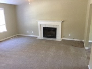 an empty living room with a fireplace in it