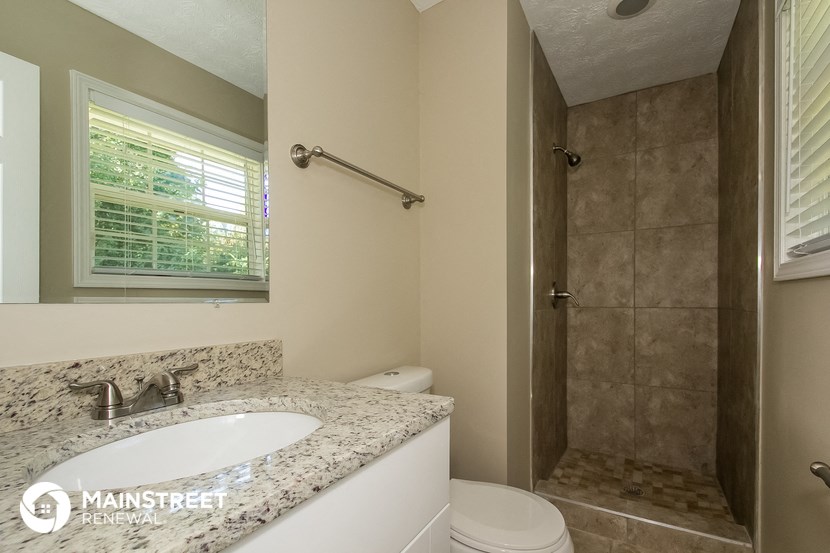 a bathroom with a sink and a shower and a toilet