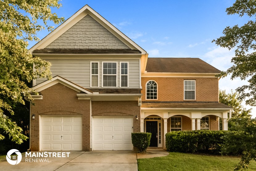 the front exterior of a house with two garage doors