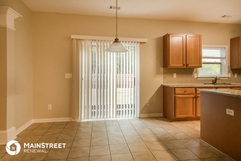 a kitchen with a sliding glass door and a sink