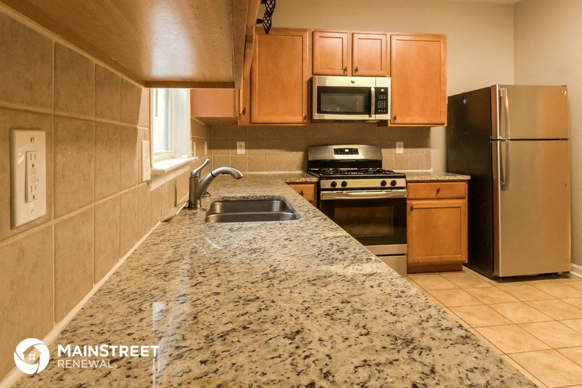 a kitchen with granite countertops and stainless steel appliances