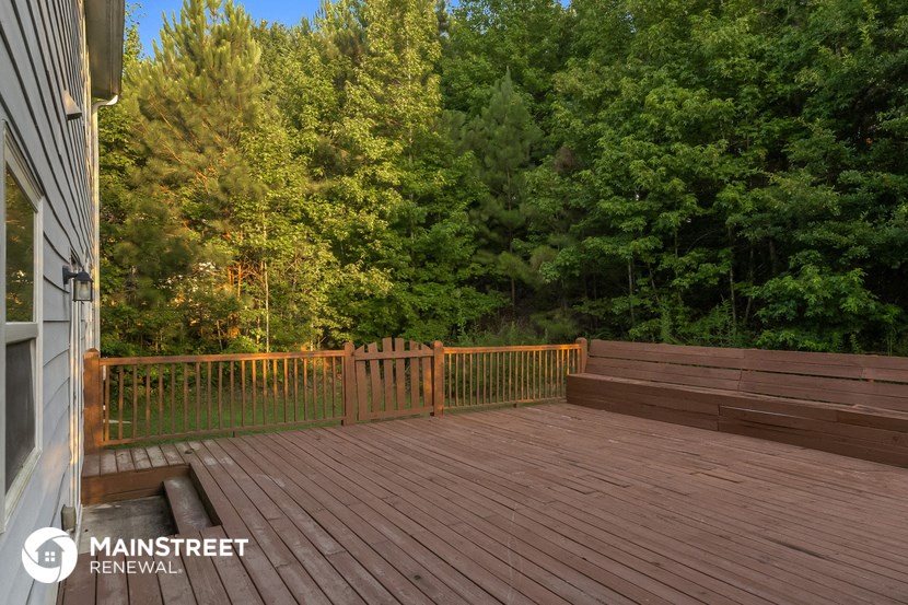 a large deck with a forest in the background