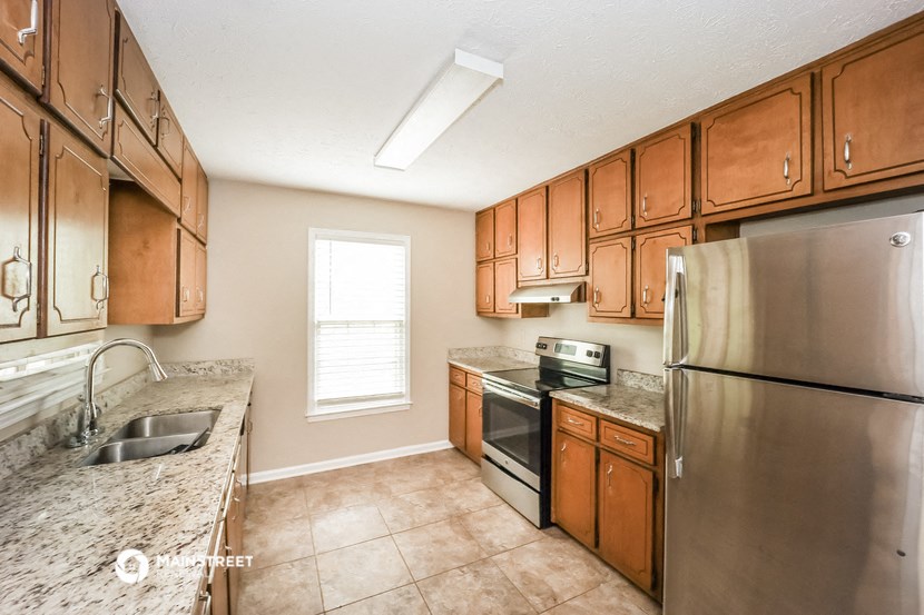 a kitchen with stainless steel appliances and wooden cabinets