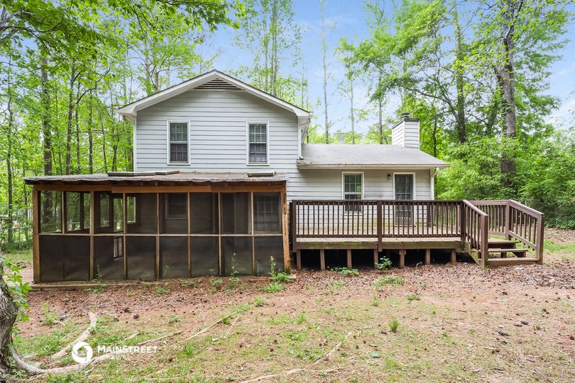 a house with a screened in porch and a deck