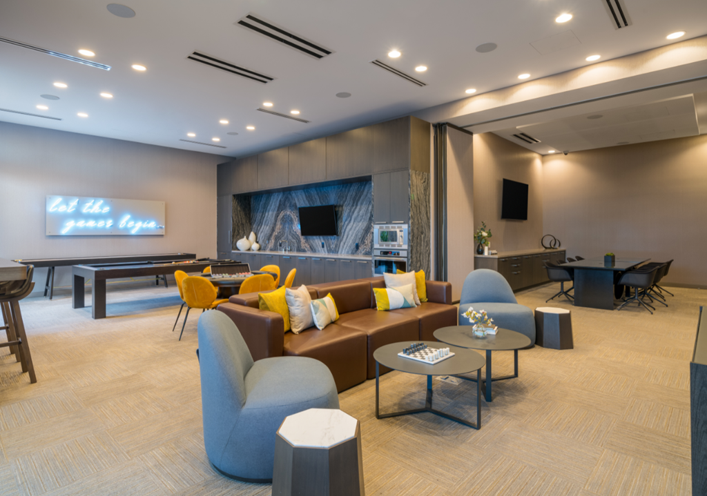 A modern living room with a large couch, chairs, and a coffee table.