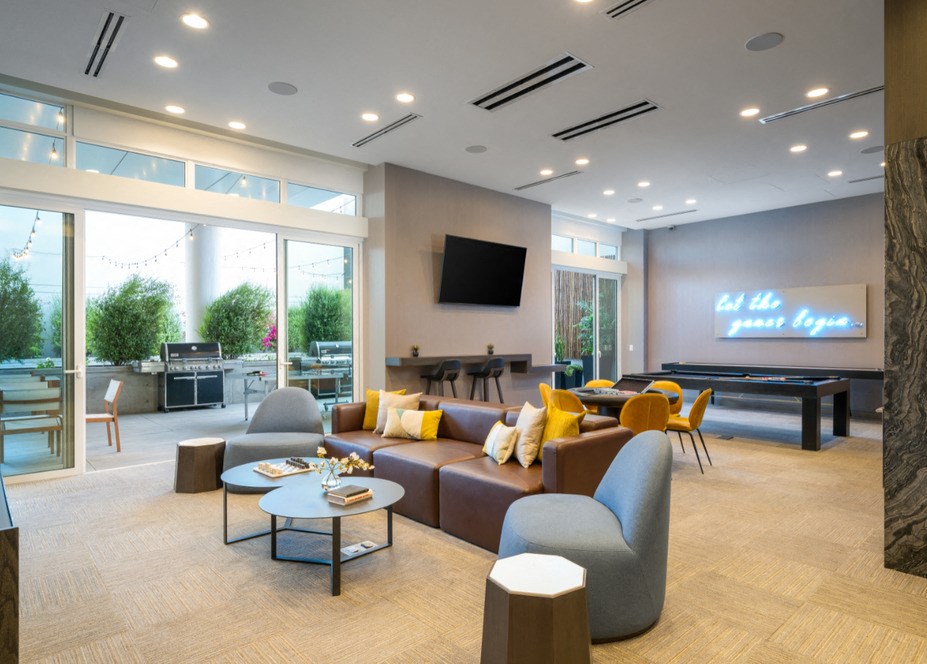 A modern living room with a pool table and a television.