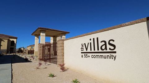 a building with the villas a 5th community sign