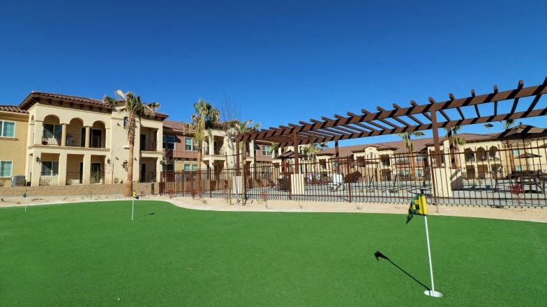 a golf course with houses in the background