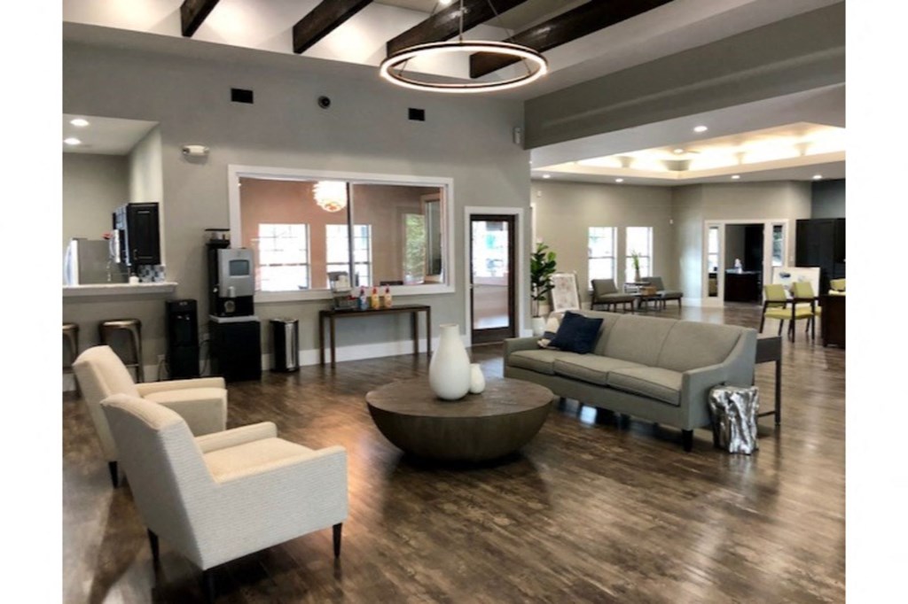 a large living room with couches and chairs and a table