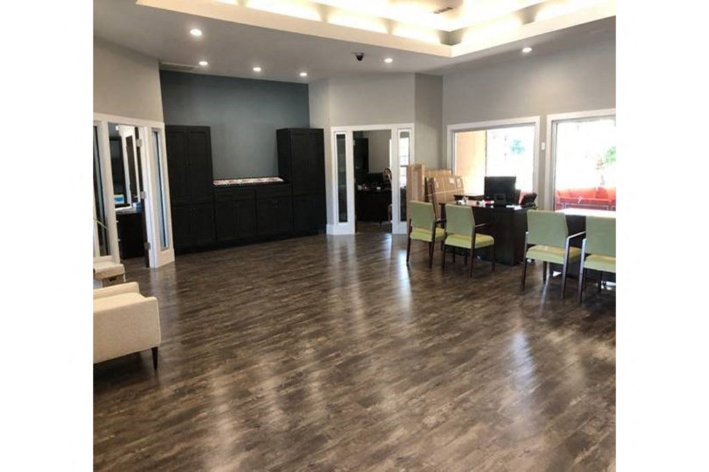 a large living room with a hard wood floor