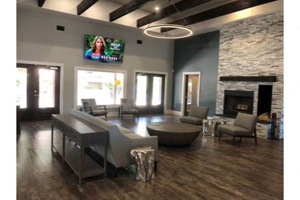a living room with a table and chairs and a fireplace