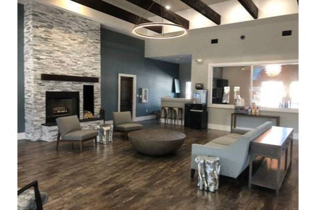 a living room with blue walls and a stone fireplace