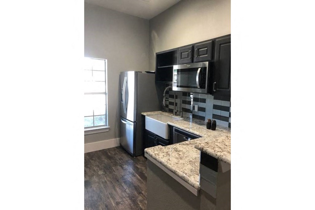a kitchen with stainless steel appliances and granite counter tops