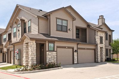 Apt building with garage Canyon Springs Apartments For Rent in Waco, Texas l Canyon Springs