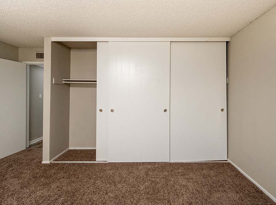 Bedroom with closet and carpet  l Forest Glenn Apartments