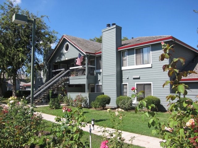 a gray house with a flag in front of it