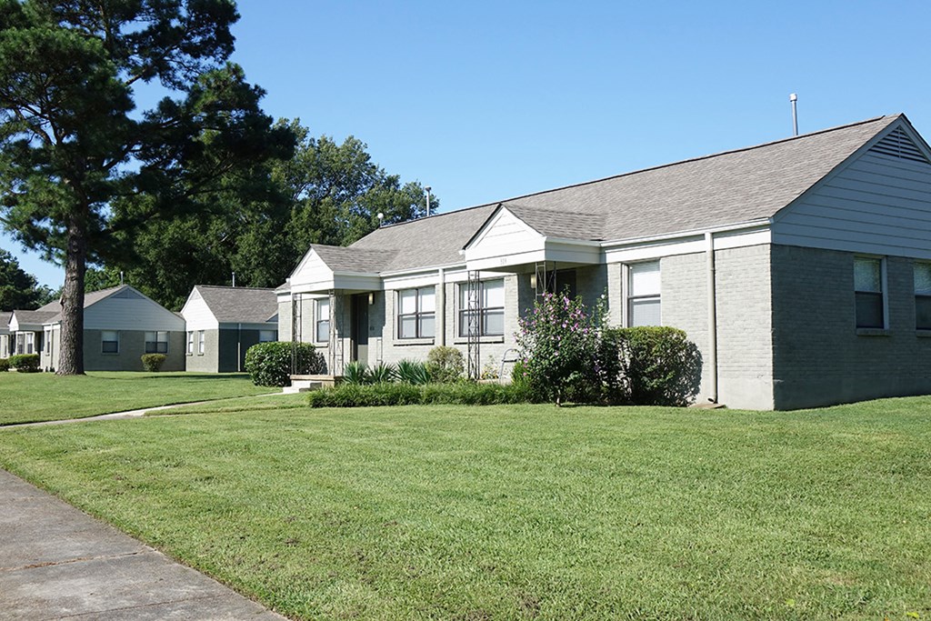 a white house with a lawn in front of it