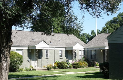 a row of houses in a neighborhood with trees