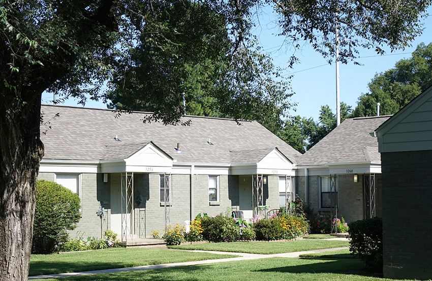 a row of houses in a neighborhood with trees