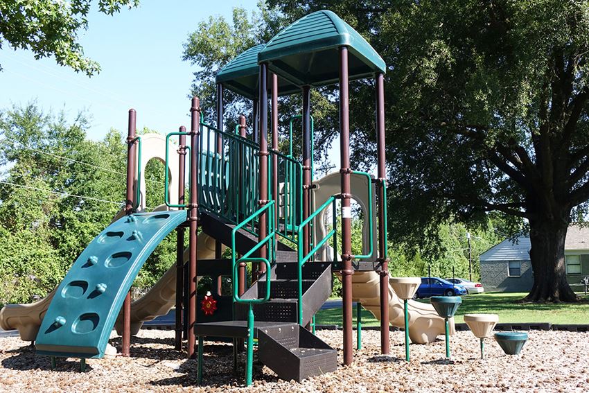 a playground with a slide and other toys in a park