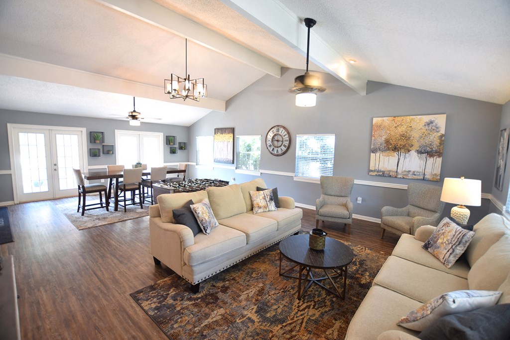 a living room and dining room with couches and a table